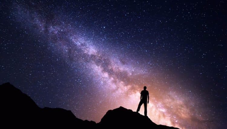 Person stargazing under the Milky Way
