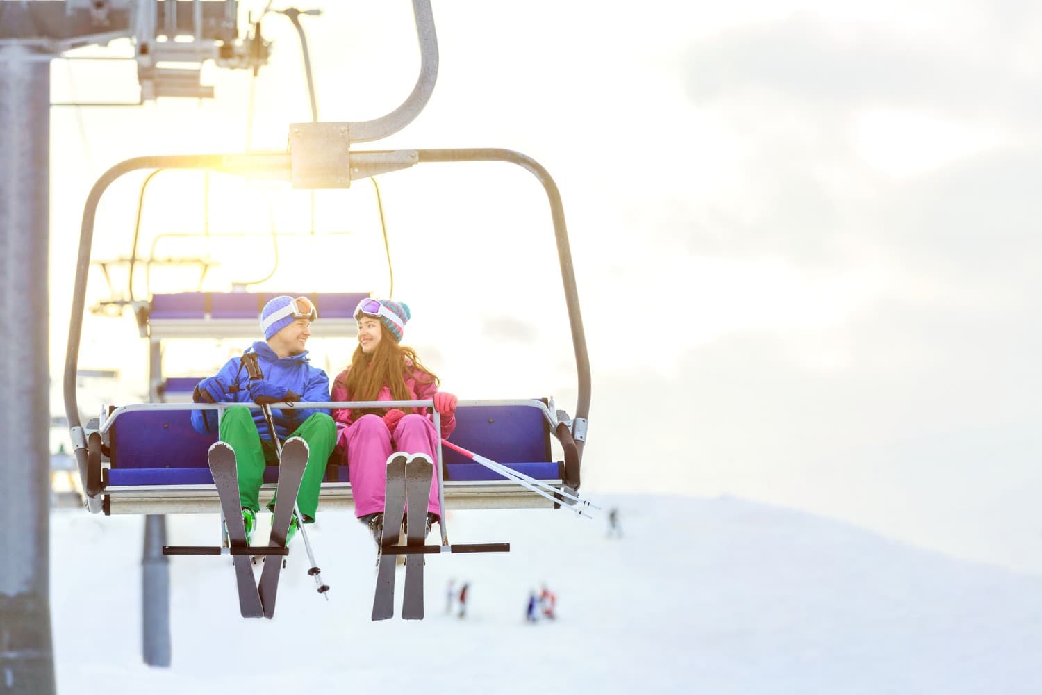 Skiers on a lift during their winter vacation