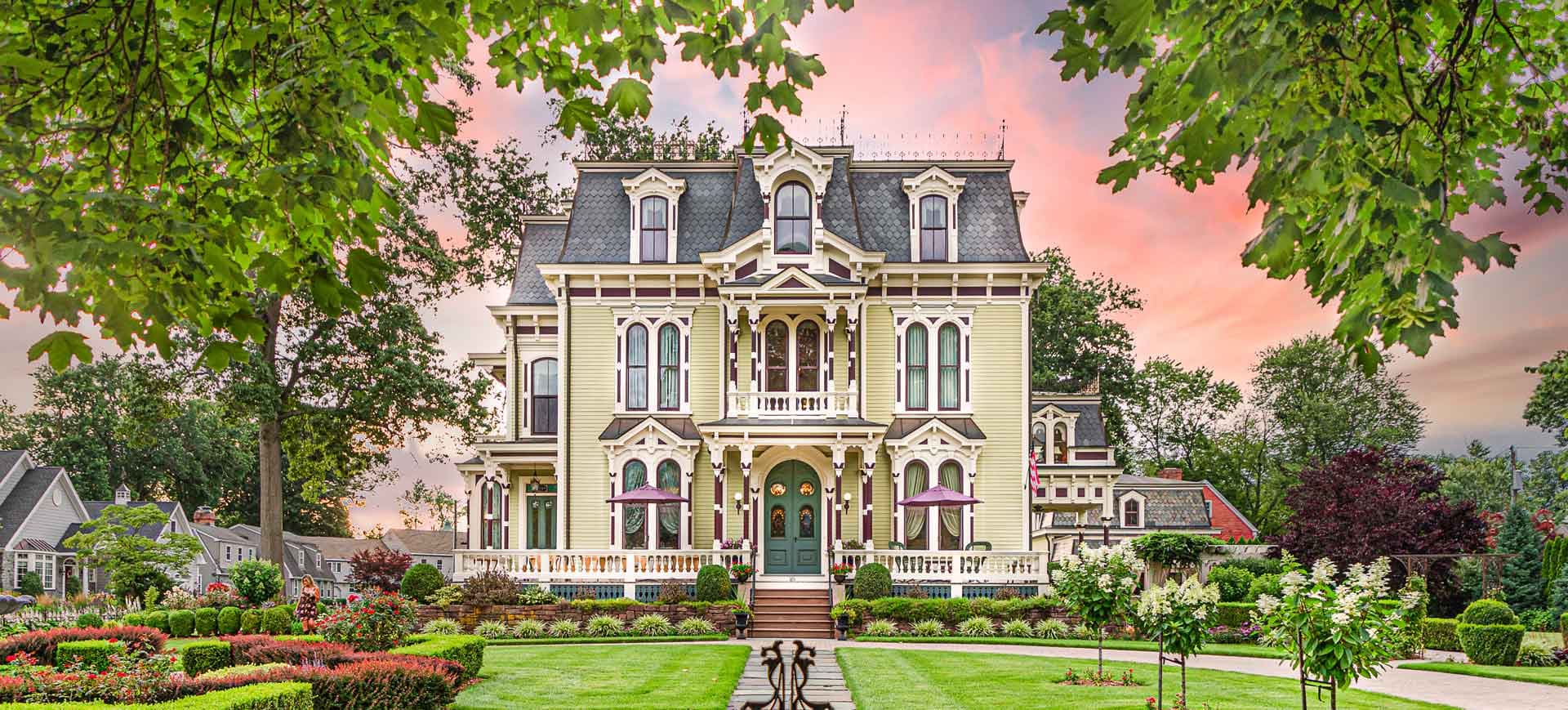 Historic home of Silas Robbins with a manicured lawn and sunset