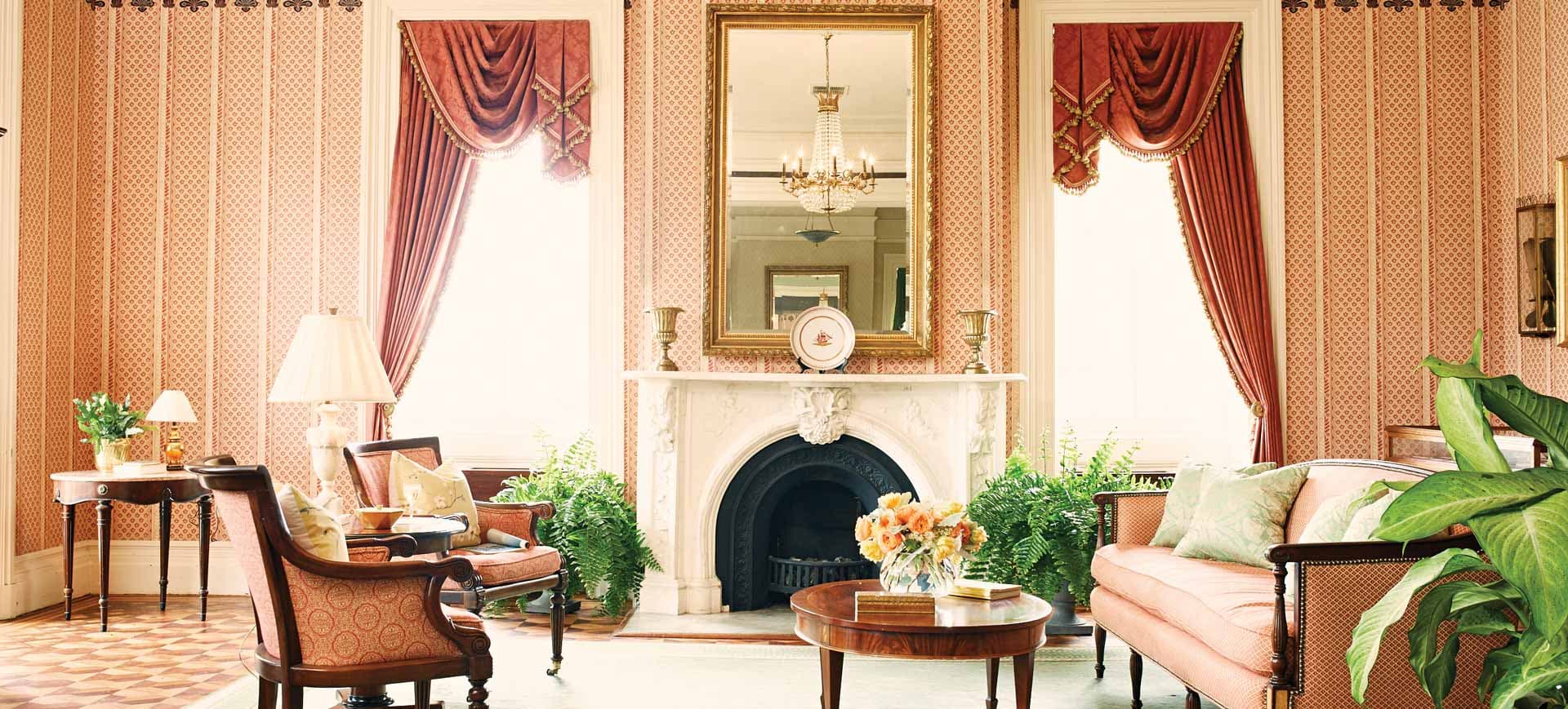 Elegant and historic living area in the John Rutledge House with a fireplace and couch