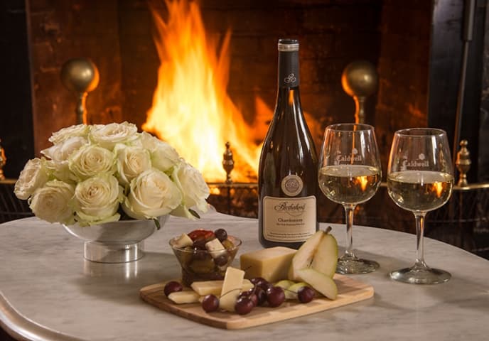 wine and cheese in front of fireplace