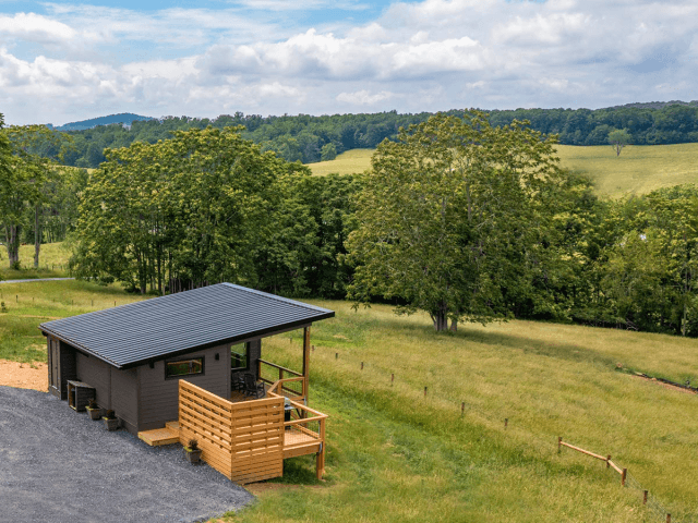 view of modern cabin with mountains in background