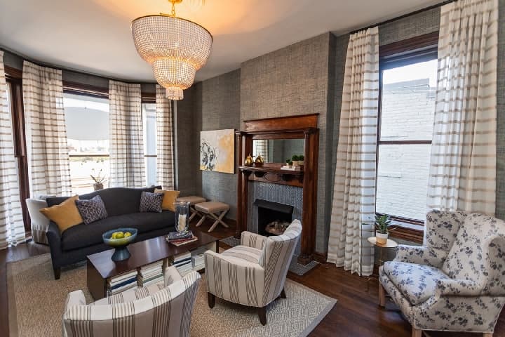 The cozy living room for guests to enjoy by the fireplace.