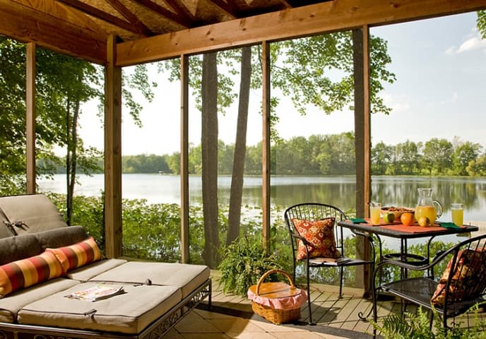 Screened porch overlooking the private lake at Castle in the Country in Southwest Michigan
