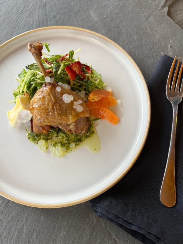 Roasted chicken on a bed of greens
