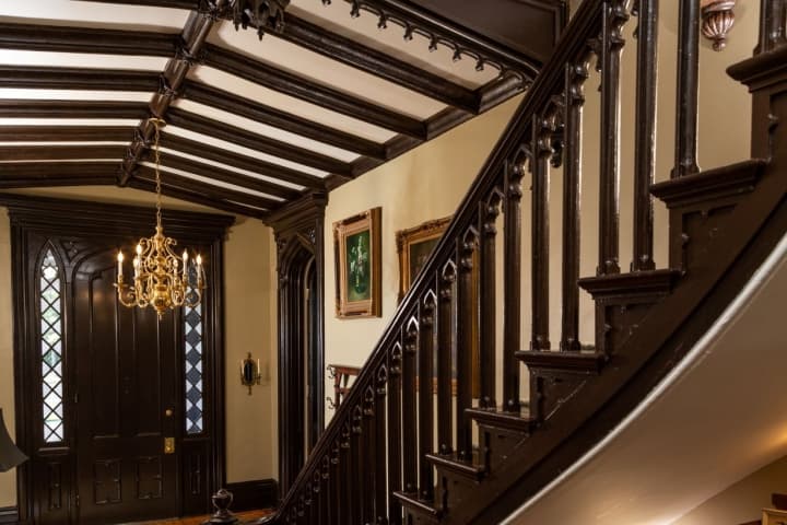 gothic staircase with ornate ballustrades and high ornamented ceiling