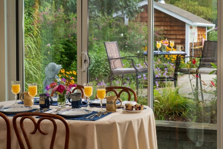 breakfast on dining room table with trees in the background