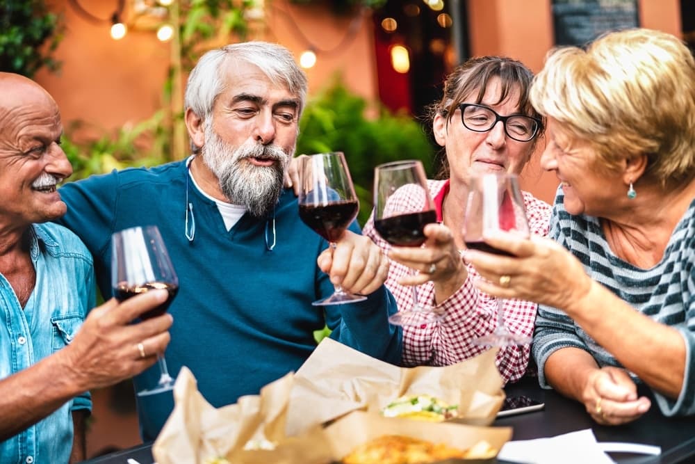 Group of senior friends enjoying a meal together at the top Pittsburg Restaurants