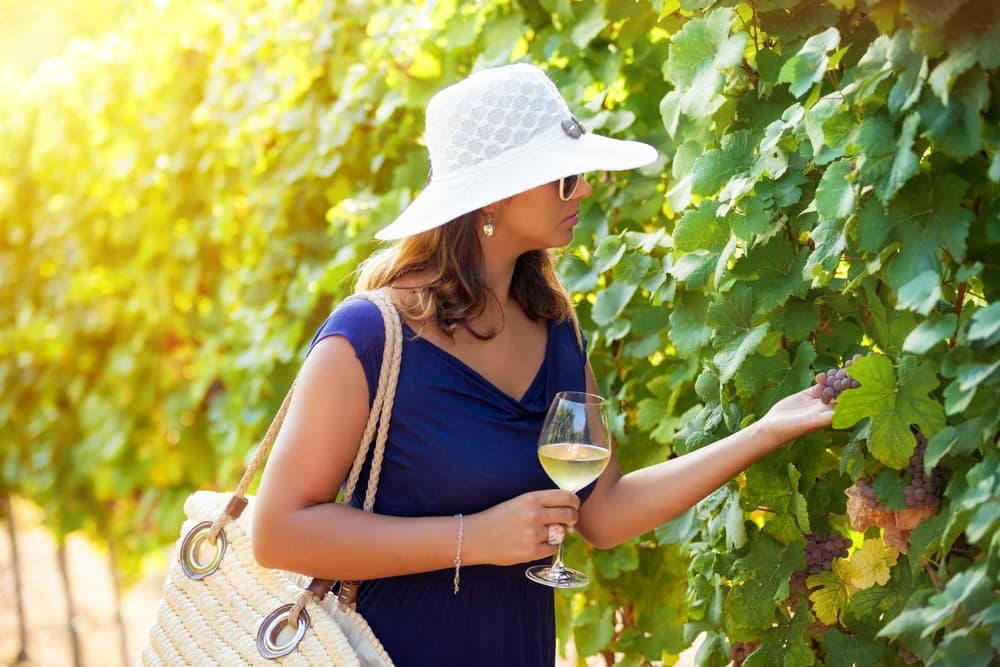 A woman enjoying Santa Barbara wine tasting in the Santa Ynez Valley in California