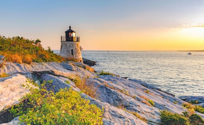 A lighthouse at sunrise on the Rhode Island coast.