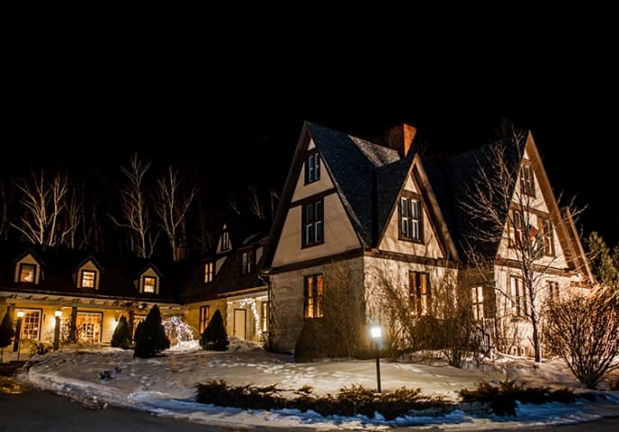 Dark night with lit up inn and snow on the ground